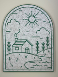 A completed wooden jigsaw puzzle depicting a cabin with surrounding nature, such as trees and a sun illustration, in a curved shape.