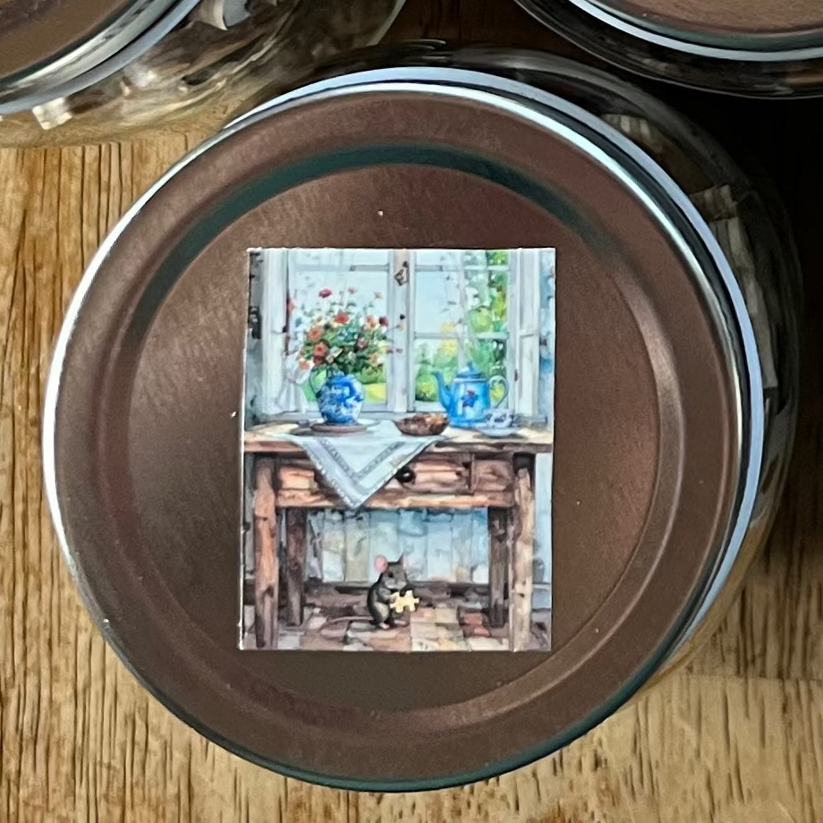 Collection of small jars with lids on a wooden surface, each containing a colorful card.
